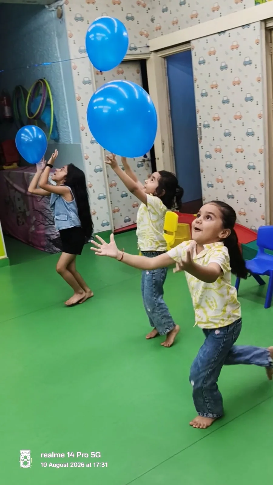 Children reaching for blue balloons