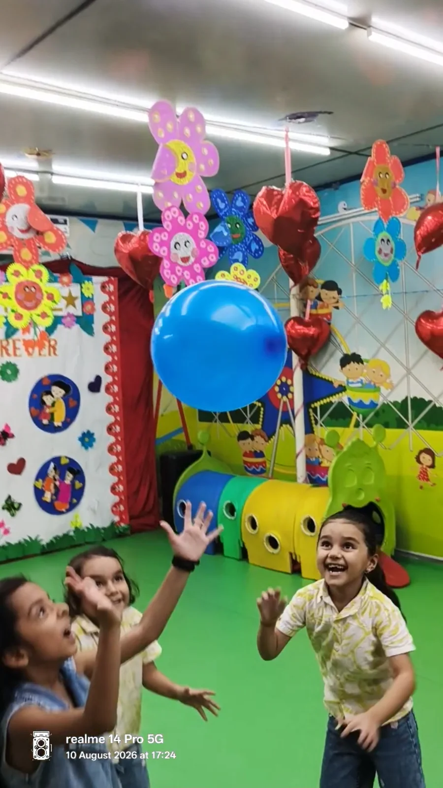 Children playing together with blue balloons