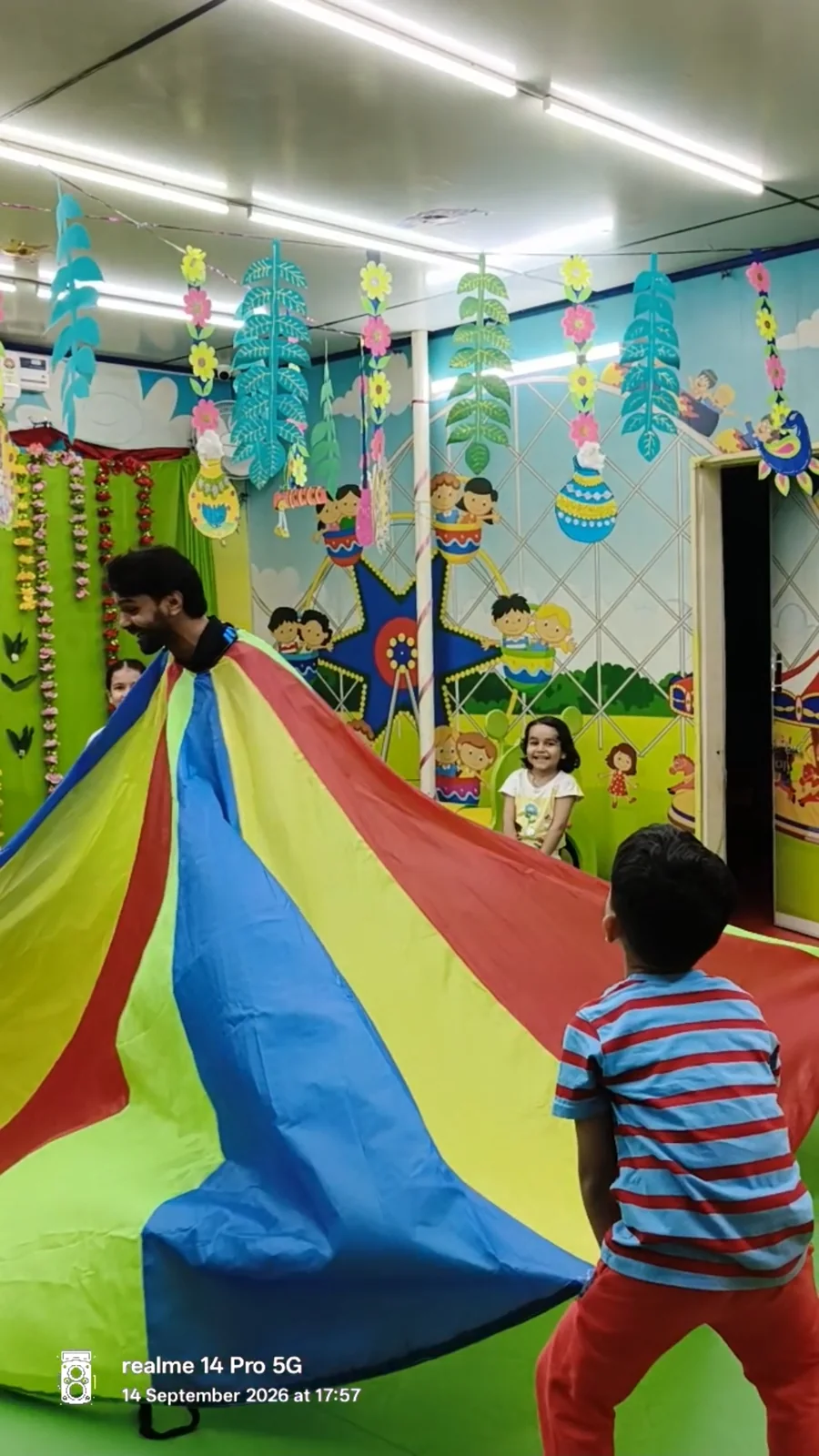 A group parachute activity in the indoor play space