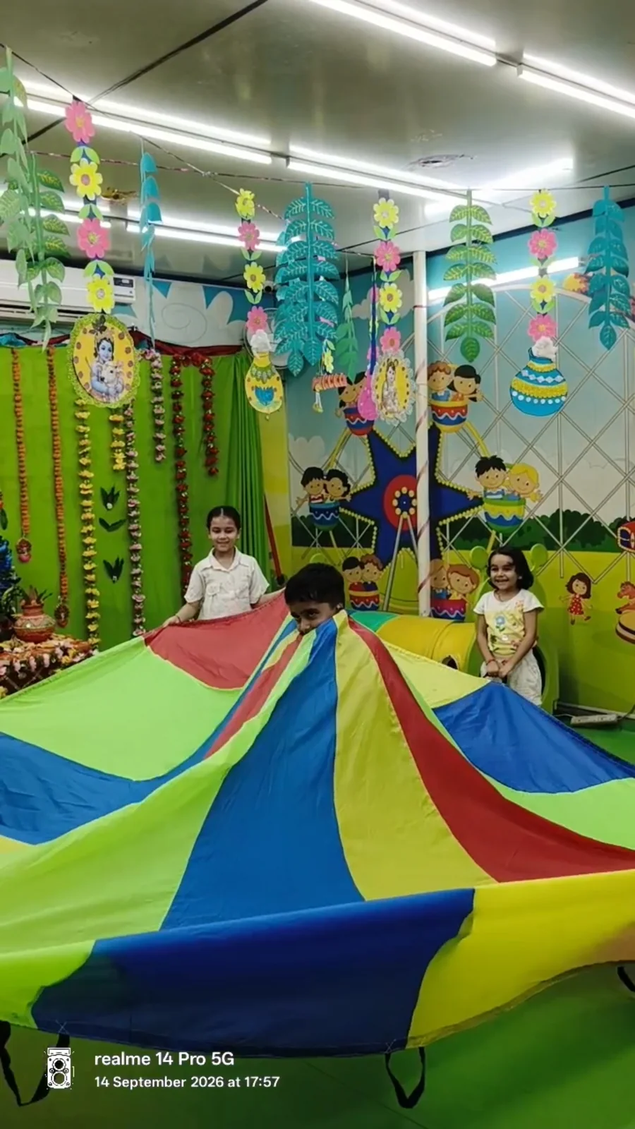Children playing together with a colourful parachute